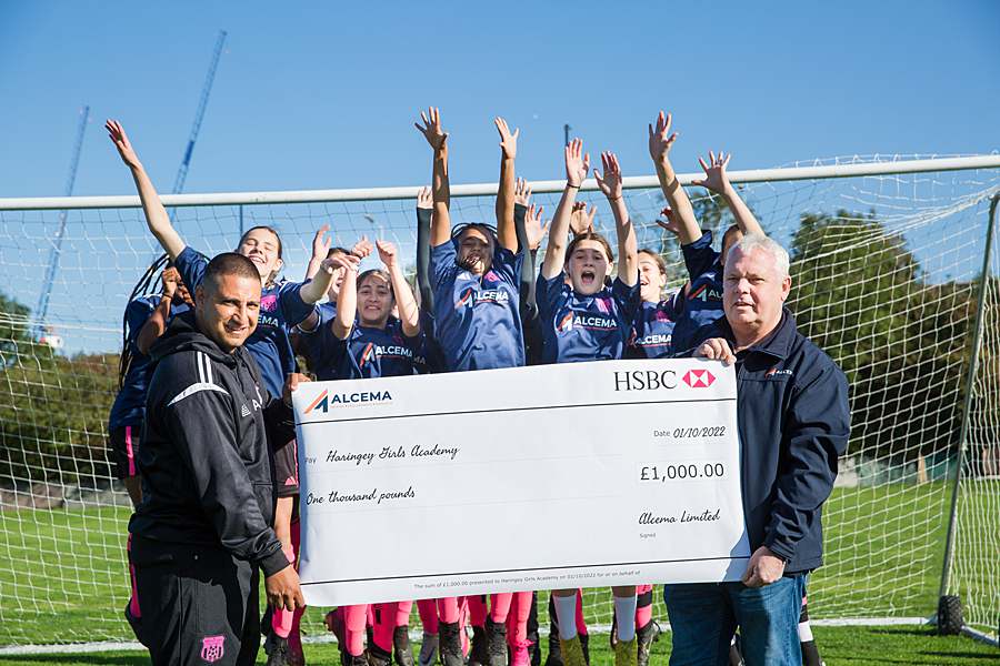 pr photography - girls football team holding a cheque