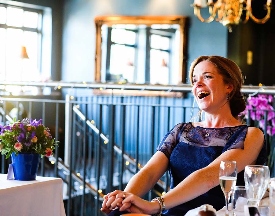 party-photographer-capturing-event-with-woman-laughing