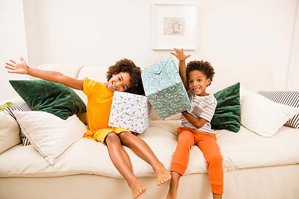 Children-model-holding-presents-in-curlicue-eco-wrapping-paper-with-smiles-by-london-website-photographer